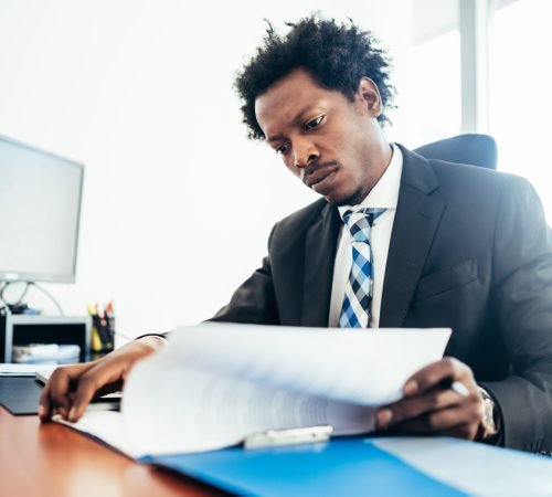Businessman working at office. Professional businessman working with some files and documents at his modern office. Business concept.